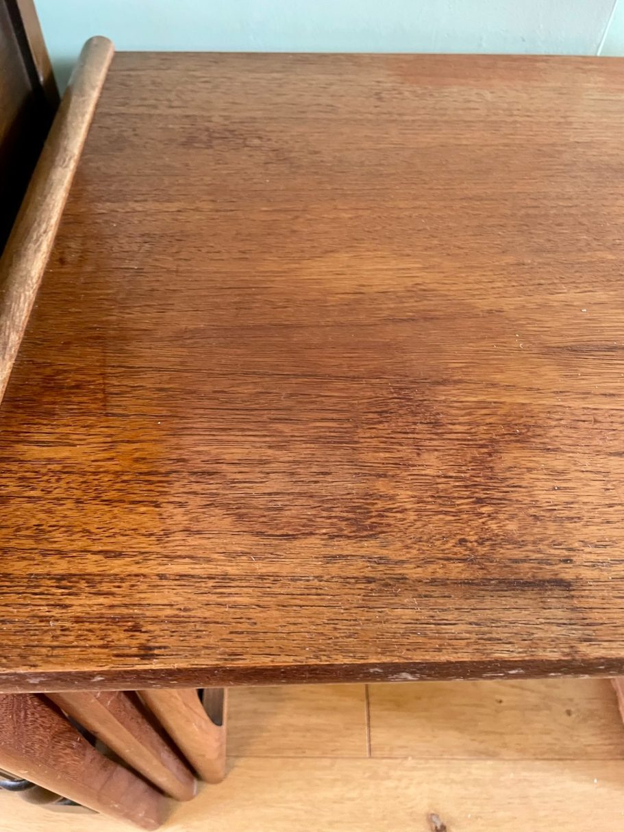 Close up of damage Close-up of a wooden table surface with a rich brown finish and subtle texture.